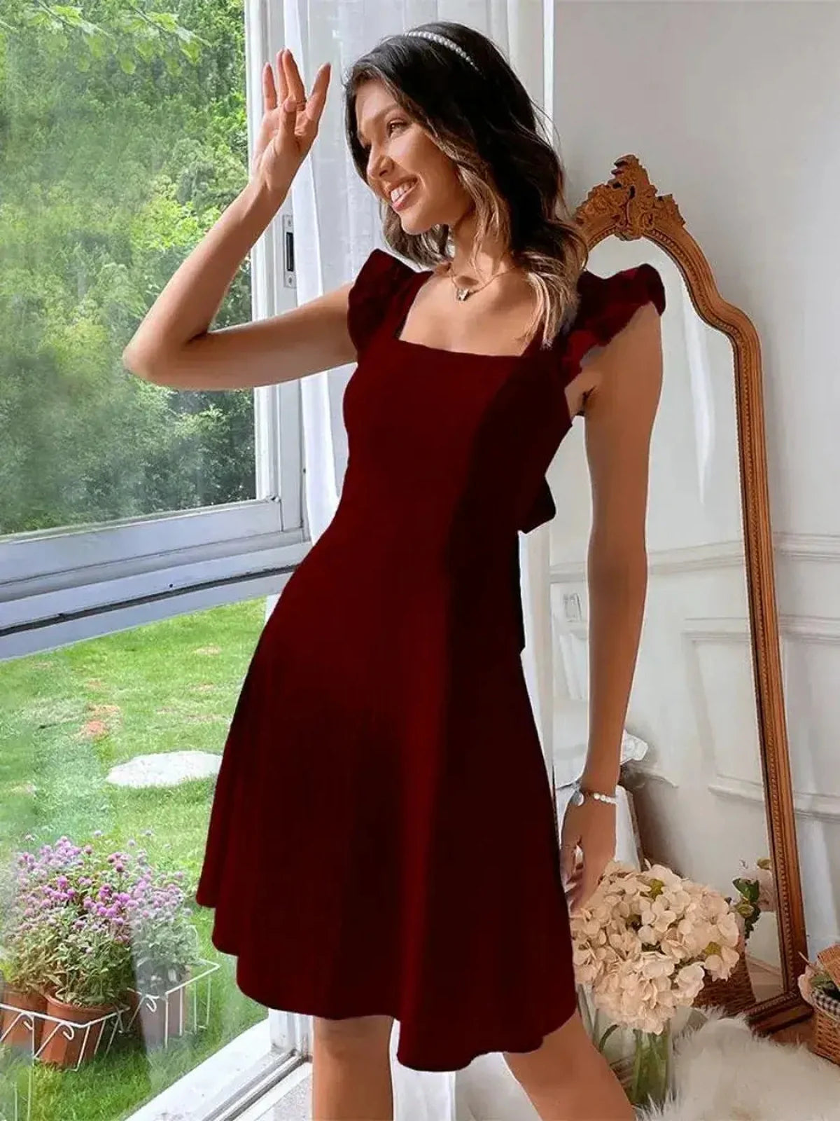 Elegant mini dress in rich red hue with square neckline and flutter sleeves, perfect for weddings and formal events.