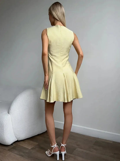 Back view of a woman wearing a sleeveless Lemon Flare dress, perfect for summer, weddings, and casual outings.