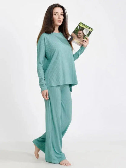 Stylish woman in a mint lounge set, featuring a soft ribbed top and wide-leg pants, embodying relaxed elegance.