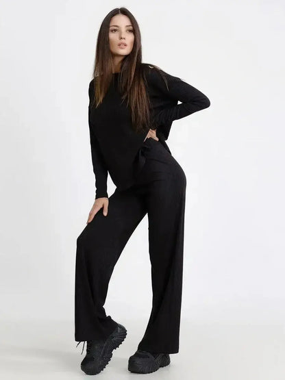 Model wearing a Jet Black Set featuring a relaxed ribbed long-sleeve top and wide-leg pants for chic comfort.