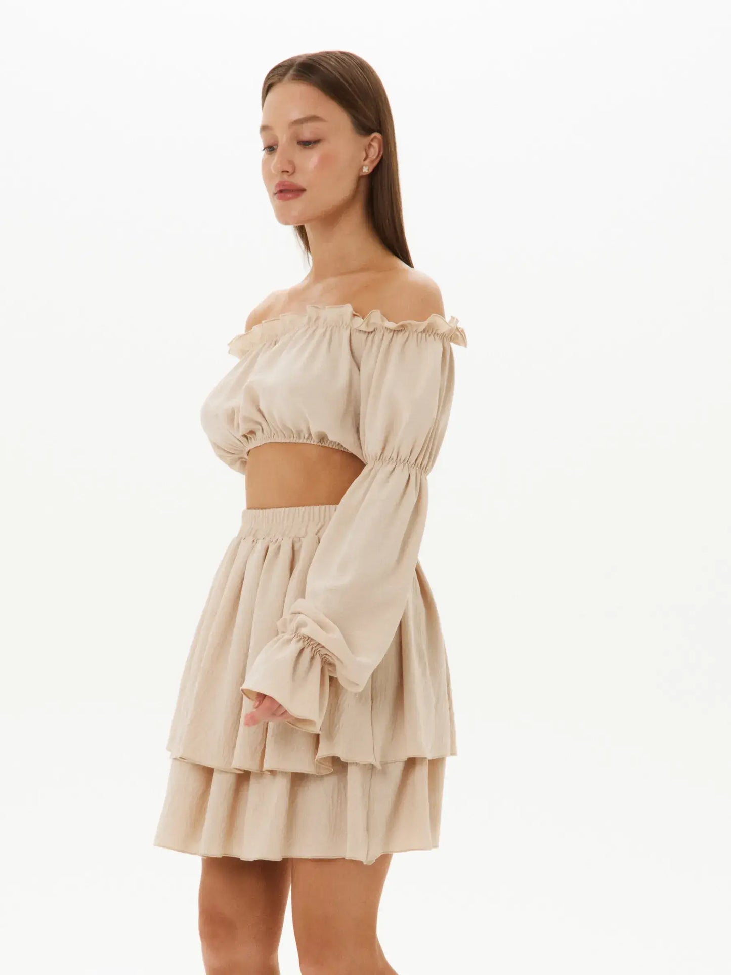 Ruffle Breeze Set featuring off-shoulder crop top and tiered mini skirt in lightweight beige fabric for summer elegance.