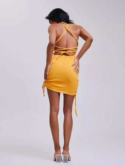 Back view of yellow mini dress with adjustable crisscross straps, perfect for summer outings and special events.