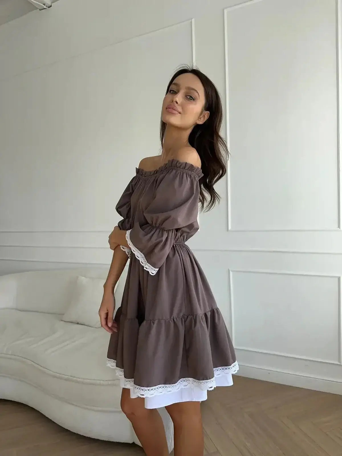Mocha Muse off-shoulder mini dress in rich mocha brown with white ruffle trim, perfect for summer weddings and casual gatherings.