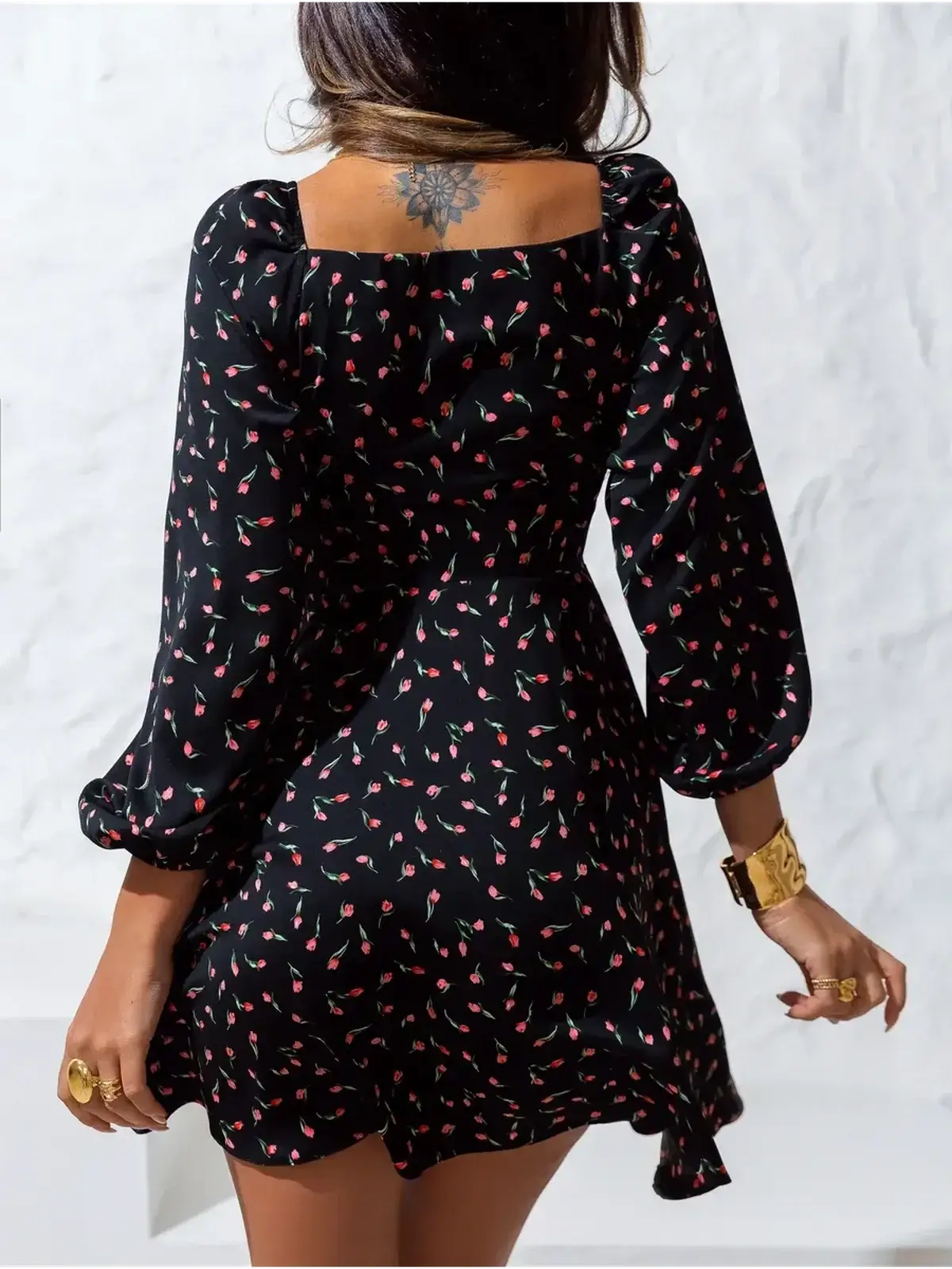 Back view of the Rose Noir mini dress featuring a floral print and puffed sleeves, perfect for weddings and special occasions.