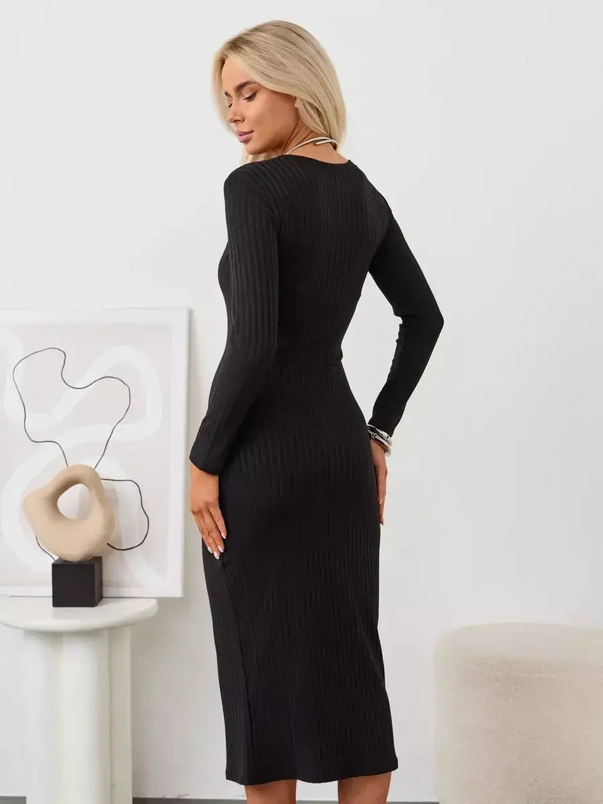 Muse Midi Dress in black, showcasing a ribbed knit design and sleek silhouette from the back, perfect for modern women.