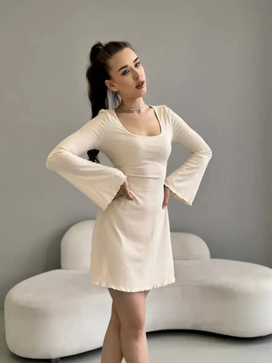 Fitted long sleeve Cream Belle mini dress in creamy white, perfect for weddings or casual gatherings, featuring a square neckline.
