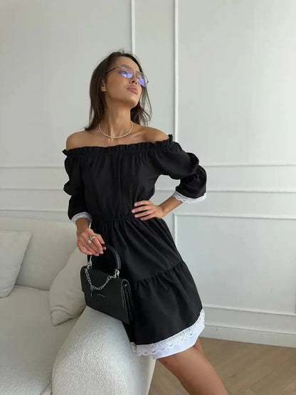 Stylish model in a black mini dress with off-shoulder neckline and white lace trim, perfect for summer and formal occasions.