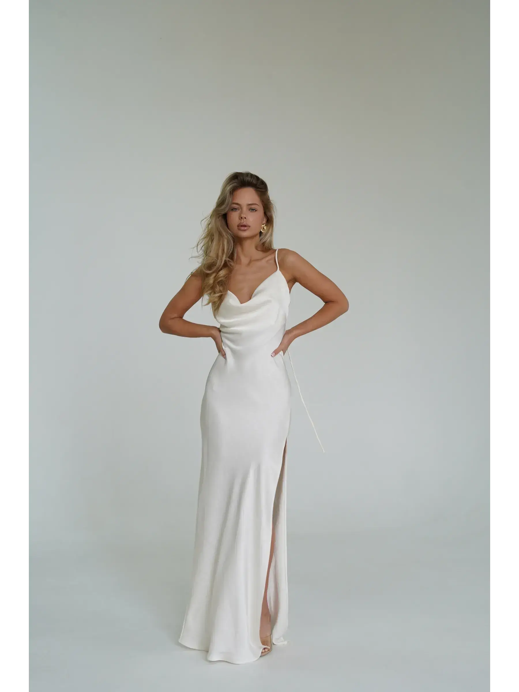 Ivory Luxe Maxi Dress showcasing silky drape, cowl neckline, and high side slit, perfect for summer events and weddings.