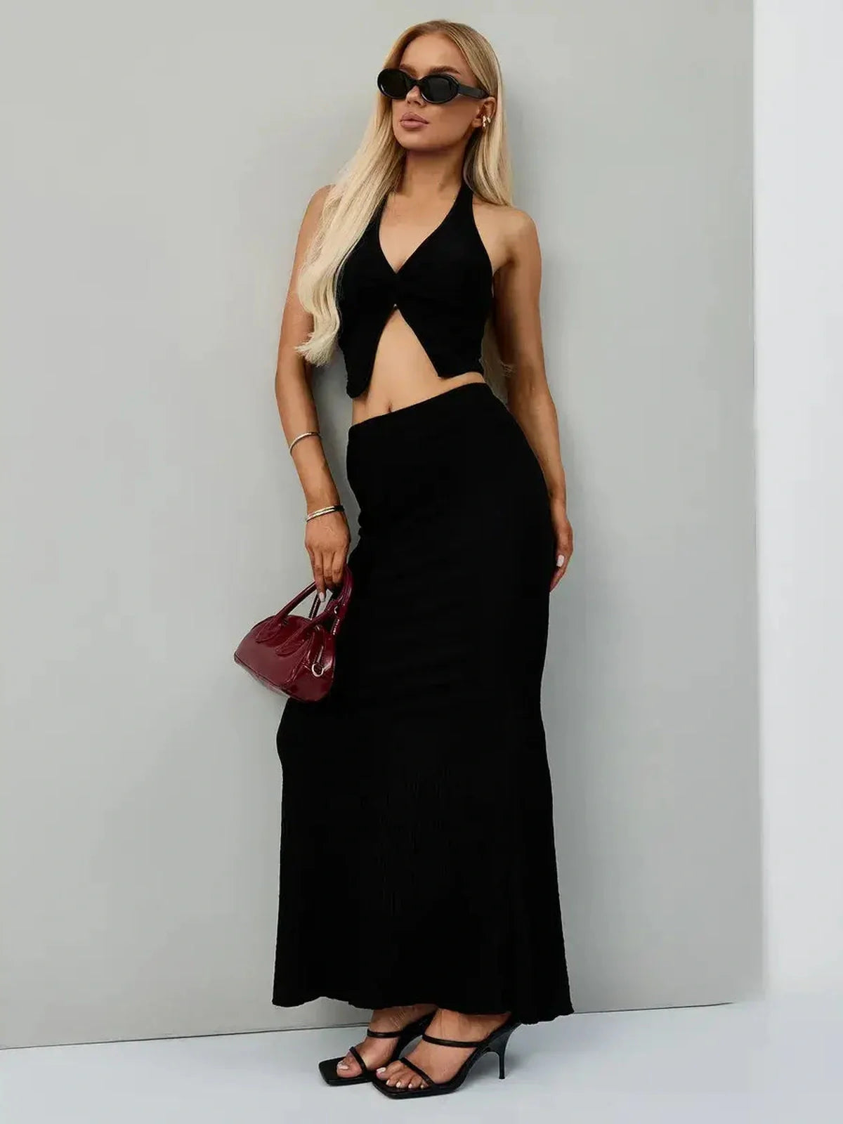 Noir Edge Set featuring a halter-neck crop top and maxi skirt in jet black, perfect for cocktail events and summer outings.