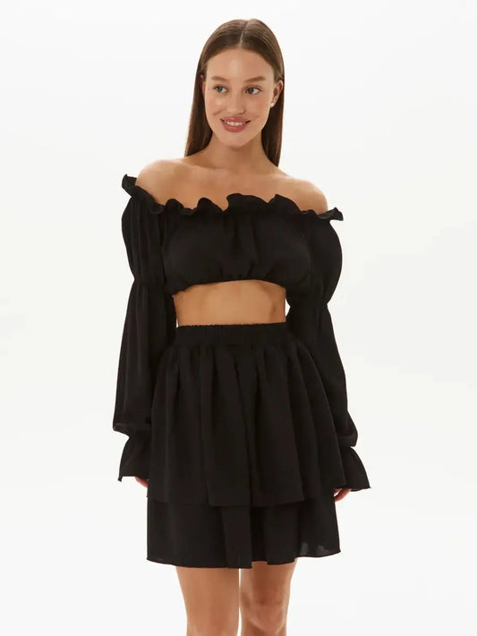 Ruffle Muse Set in black – off-shoulder top and tiered mini skirt, perfect for summer events and casual occasions.