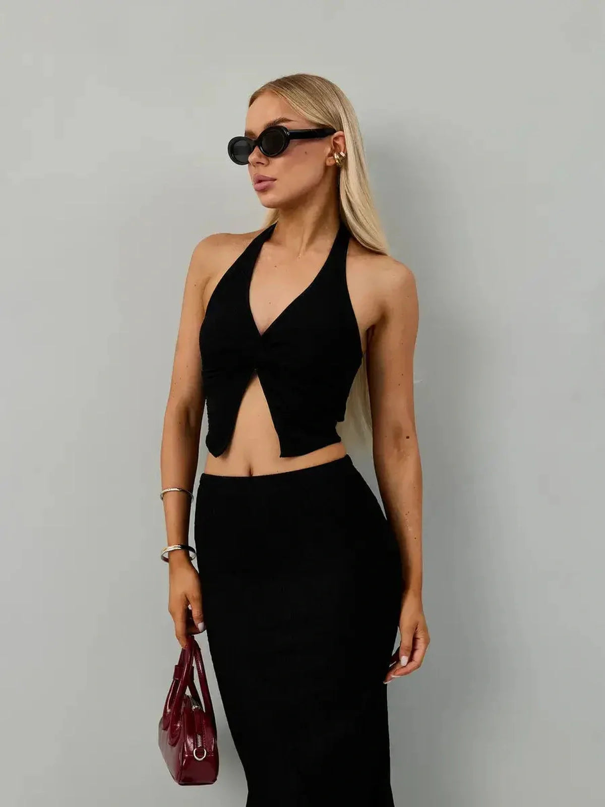 Model wearing Noir Edge Set black halter top and maxi skirt, perfect for weddings, proms, or evening events.