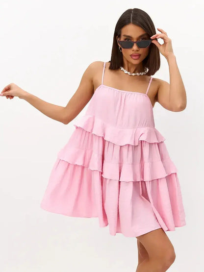 Model wearing a pink mini dress with cascading ruffles, perfect for summer, weddings, and casual outings.