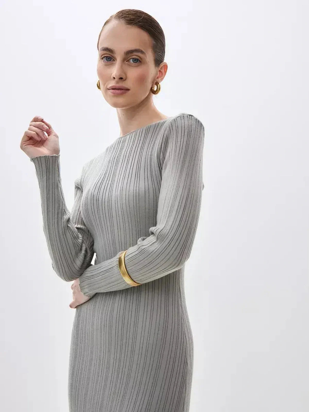 Sculpted Grace Maxi Dress in ribbed knit, showcasing elegant long sleeves and stylish accessories.