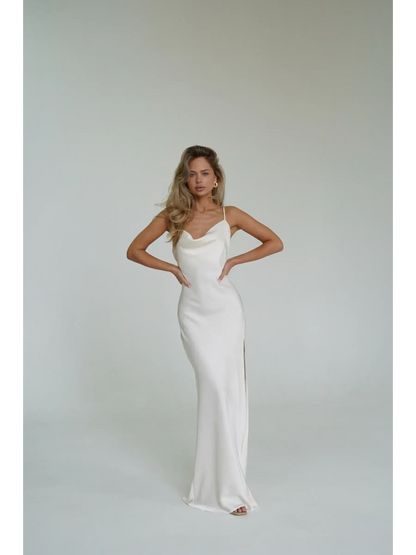 Model showcasing the Ivory Luxe Maxi Dress featuring a cowl neckline and high side slit, perfect for summer events.