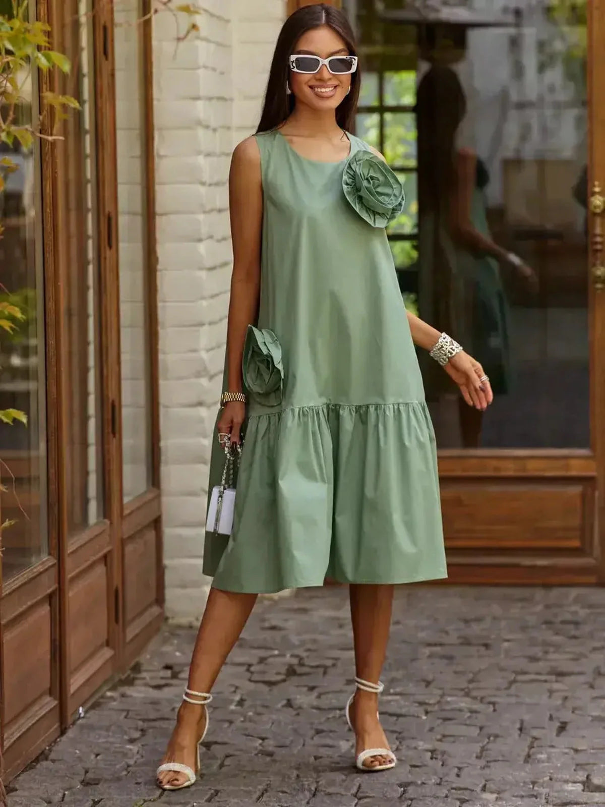 Elegant green sleeveless Petal Bloom Midi Dress with floral accents, perfect for wedding guest or summer occasions.