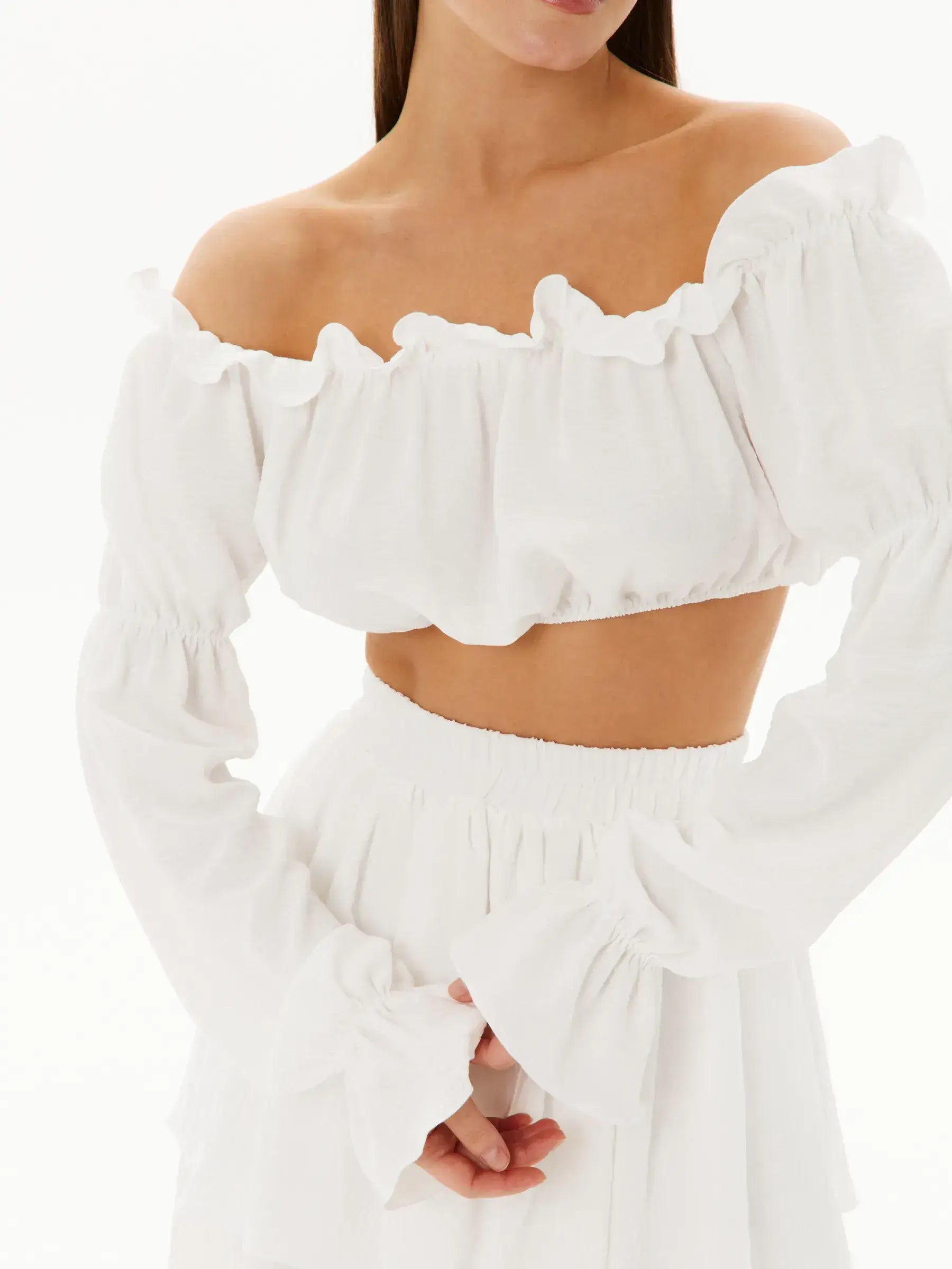 White ruffle off-shoulder top with feminine details, perfect for summer, garden parties, and weddings.