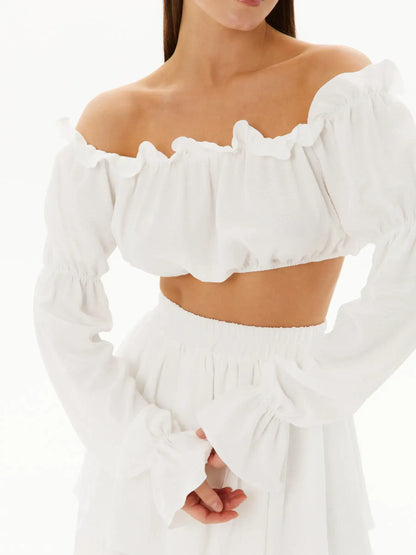 White ruffle off-shoulder top with feminine details, perfect for summer, garden parties, and weddings.