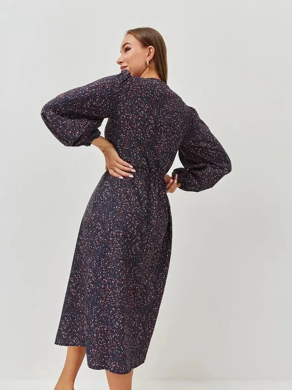 Back view of the Midi Dress Nocturne Bloom with long sleeves, featuring a wrap silhouette and a playful micro-print.