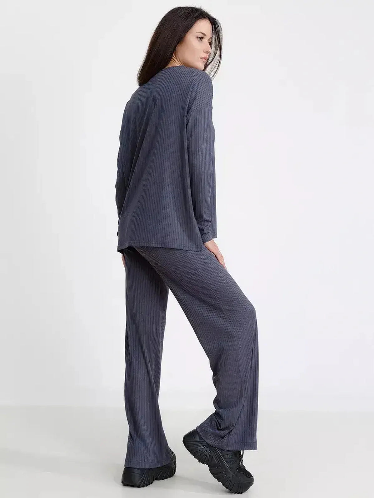 Woman wearing a stylish oversized slate lounge set featuring a ribbed knit design for comfort and elegance.