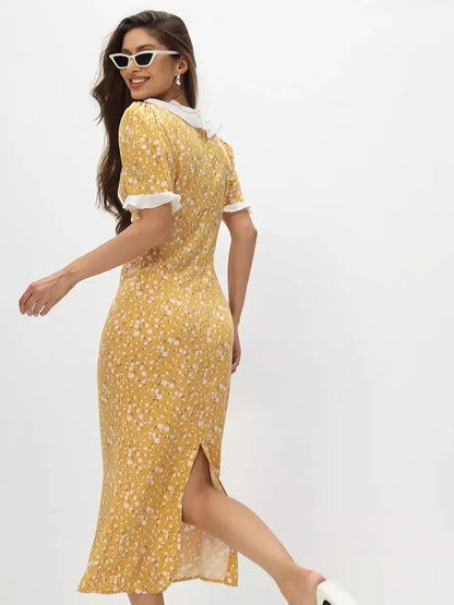 Woman wearing a yellow floral midi dress with ruffles and white collar, ideal for summer events and weddings.