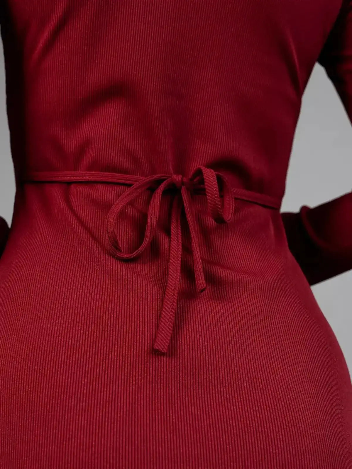 Close-up of the adjustable lace-up back detail of the sultry Crimson Flare red dress.
