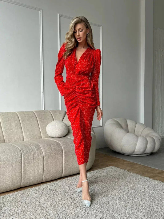 Model showcasing the Starlight Midi Dress in red satin with polka dots, featuring a flattering silhouette.