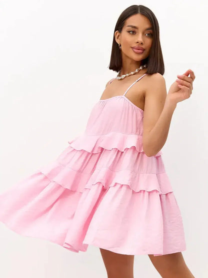 Playful pink mini dress with tiered ruffles, perfect for summer, weddings, and special occasions.