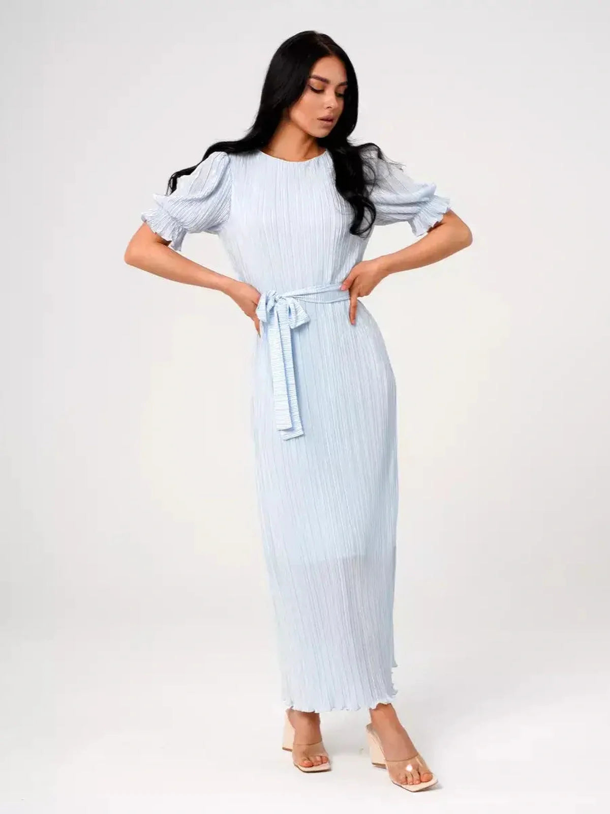 Light blue Celeste Flow Maxi Dress with pleated design and waist tie, perfect for summer weddings and formal events.