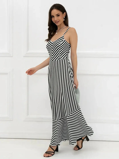 Elegant black and white striped maxi dress featuring a fitted bodice and A-line silhouette, ideal for weddings or summer outings.