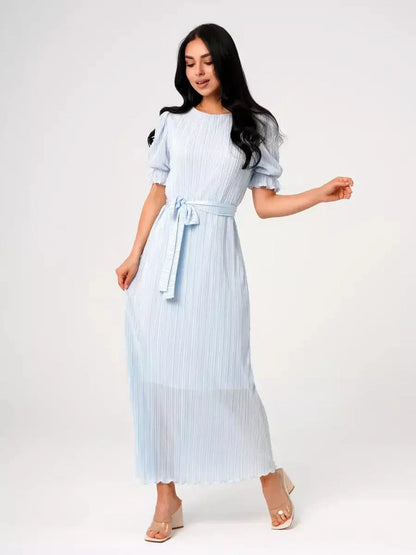 Light blue Celeste Flow Maxi Dress with pleats and waist tie, perfect for summer weddings and elegant occasions.