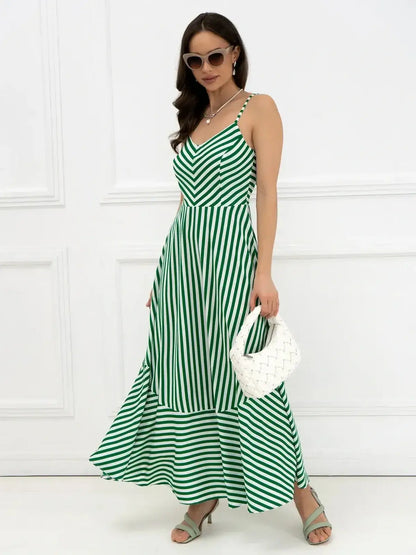 Woman in green and white striped maxi dress with bow detail, perfect for summer or wedding guest attire.