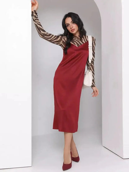 Model wearing the Satin Charm Midi Dress in burgundy, showcasing its fluid satin slip and adjustable straps.