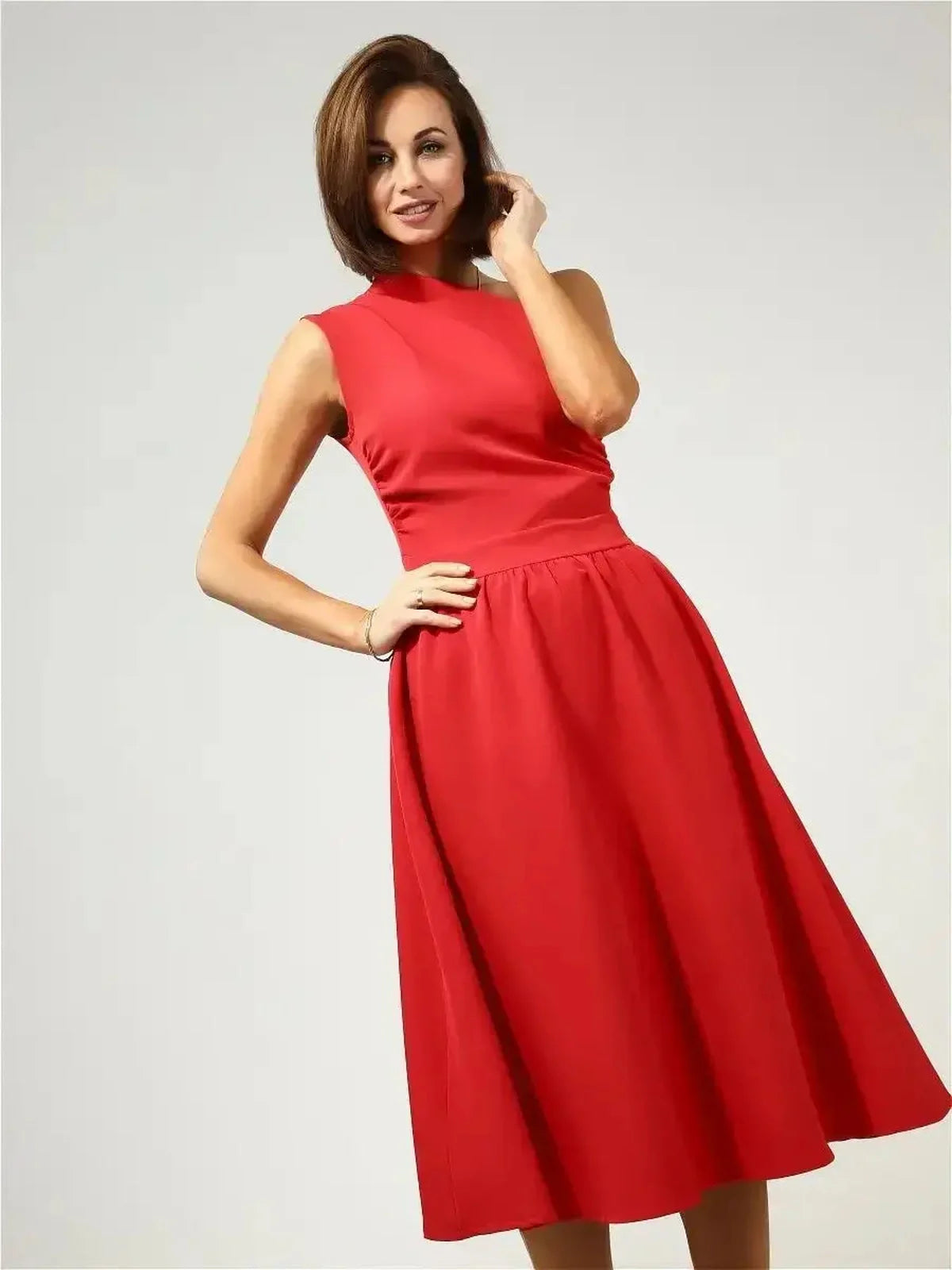 Model showcasing the Scarlet Sway Midi Dress in vibrant red, featuring a one-shoulder design and flared skirt.