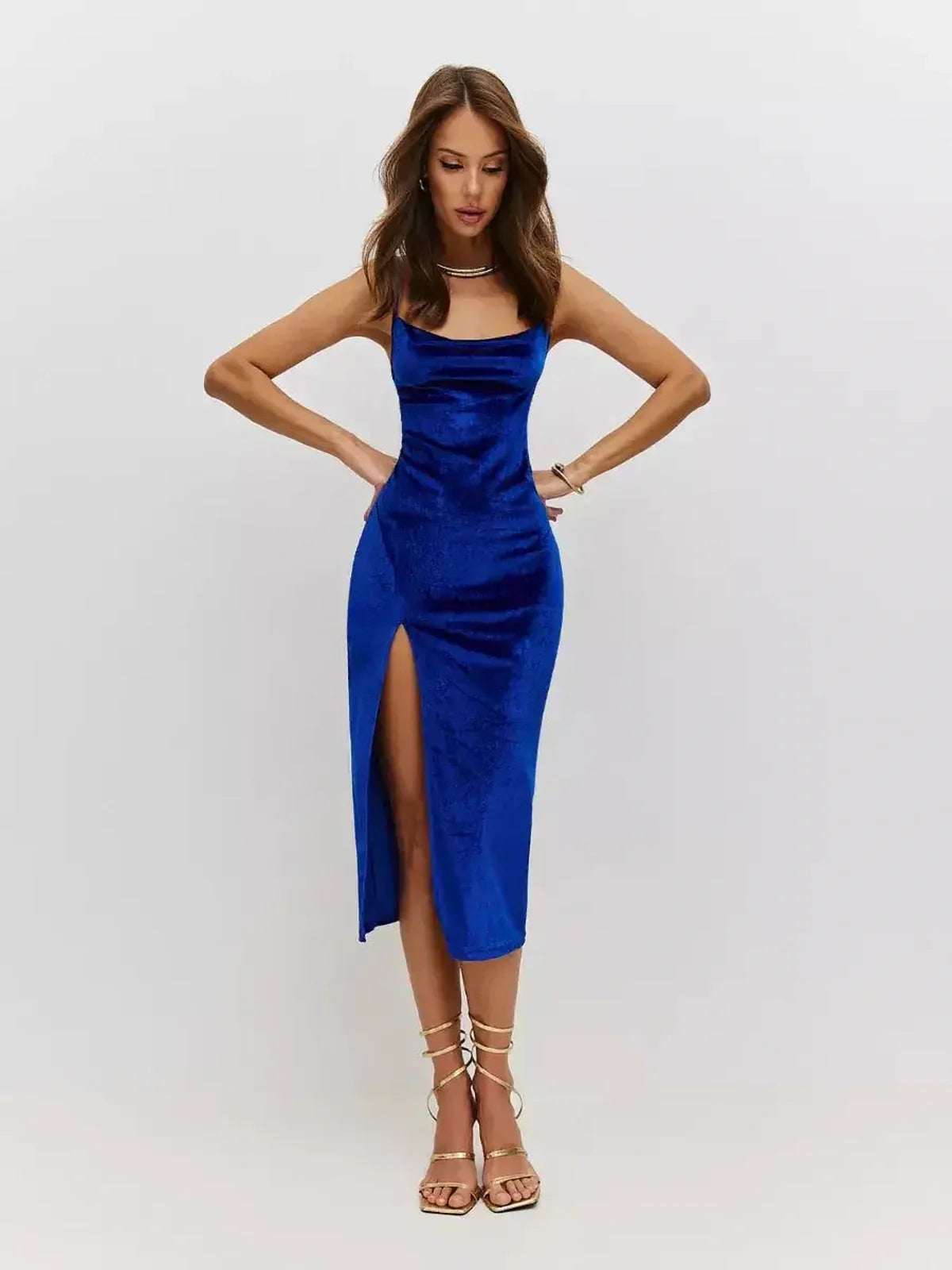 Model wearing a royal blue velvet midi dress with a cowl neckline and thigh-high slit, perfect for formal occasions.