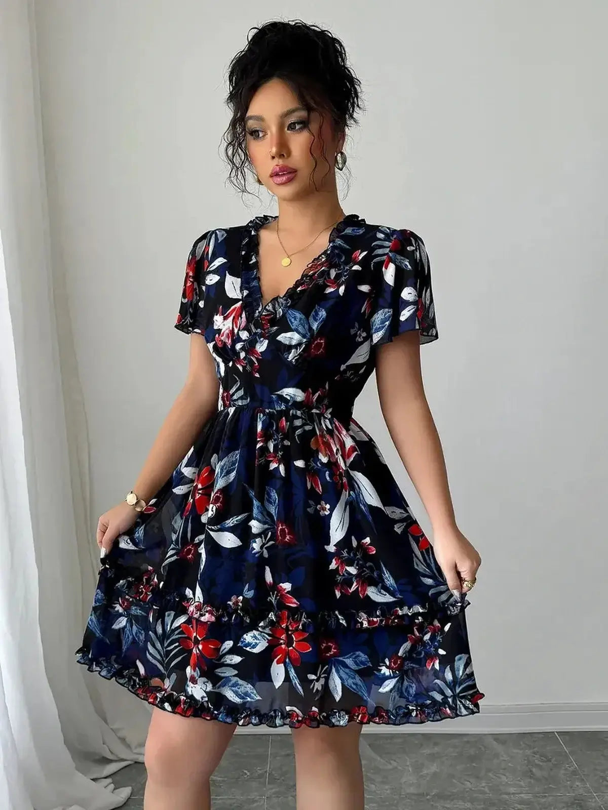 Elegant floral mini dress in navy with ruffles, perfect for wedding guests or summer parties.