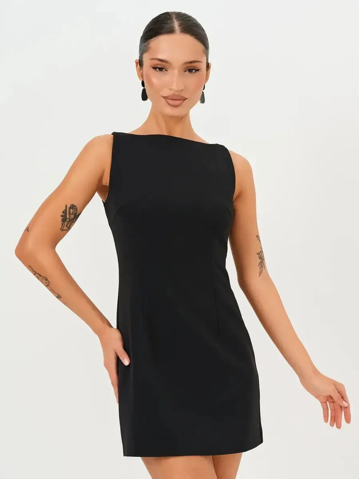 Model wearing a sleek black Jet Luxe Mini Dress, perfect for wedding guest, prom, or cocktail events.