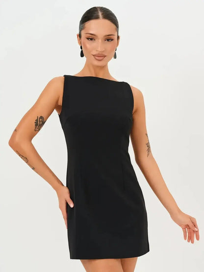 Model wearing a sleek black Jet Luxe Mini Dress, perfect for wedding guest, prom, or cocktail events.