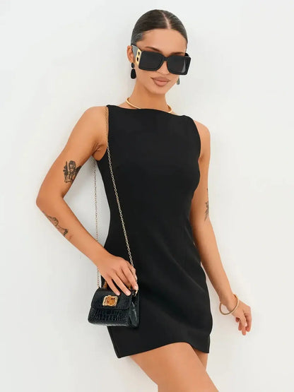 Model showcasing the Jet Luxe Mini Dress in black, perfect for cocktail events and stylish occasions.