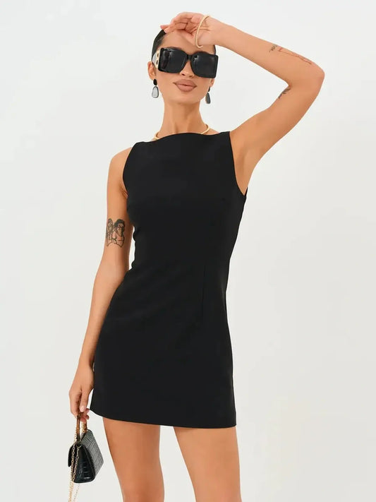 Model showcasing a Jet Luxe Mini Dress in black, perfect for summer parties or formal events.