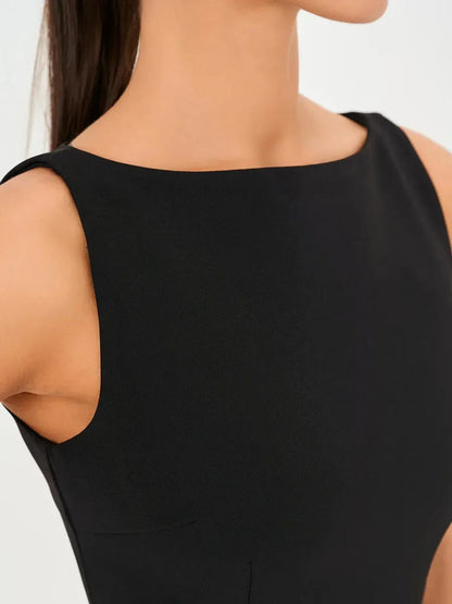Close-up of the Jet Luxe Mini Dress featuring a sleek round neckline and form-fitting black design.