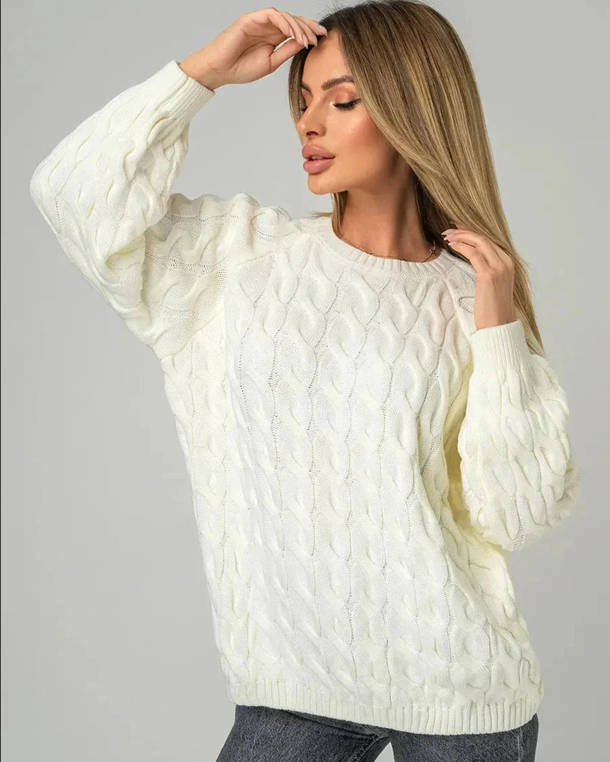 Model wearing the Alabaster Sweater by Slimona, showcasing the oversized cream cable knit design.