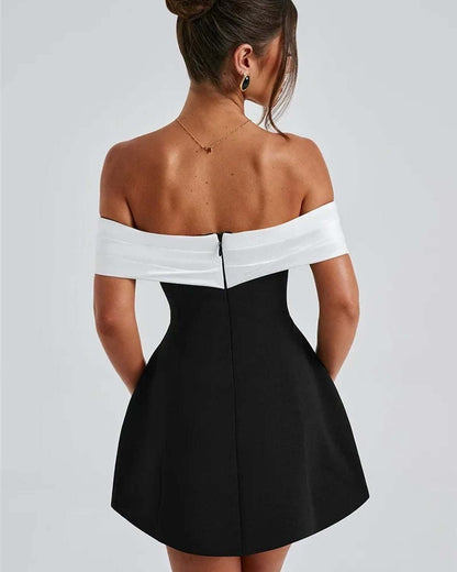 Back view of the Alba Mini Dress featuring an off-shoulder satin neckline and oversized white bow, perfect for summer events.