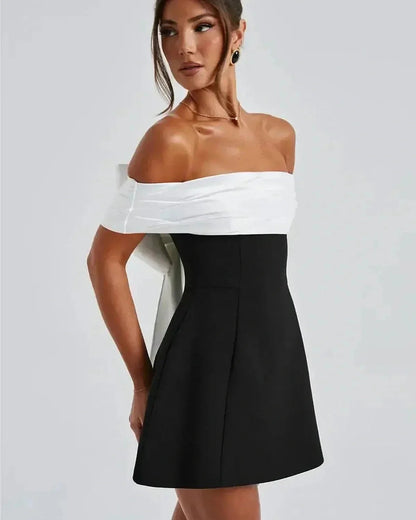 Alba Mini Dress featuring an off-shoulder satin neckline and oversized white bow, perfect for wedding guests and summer parties.