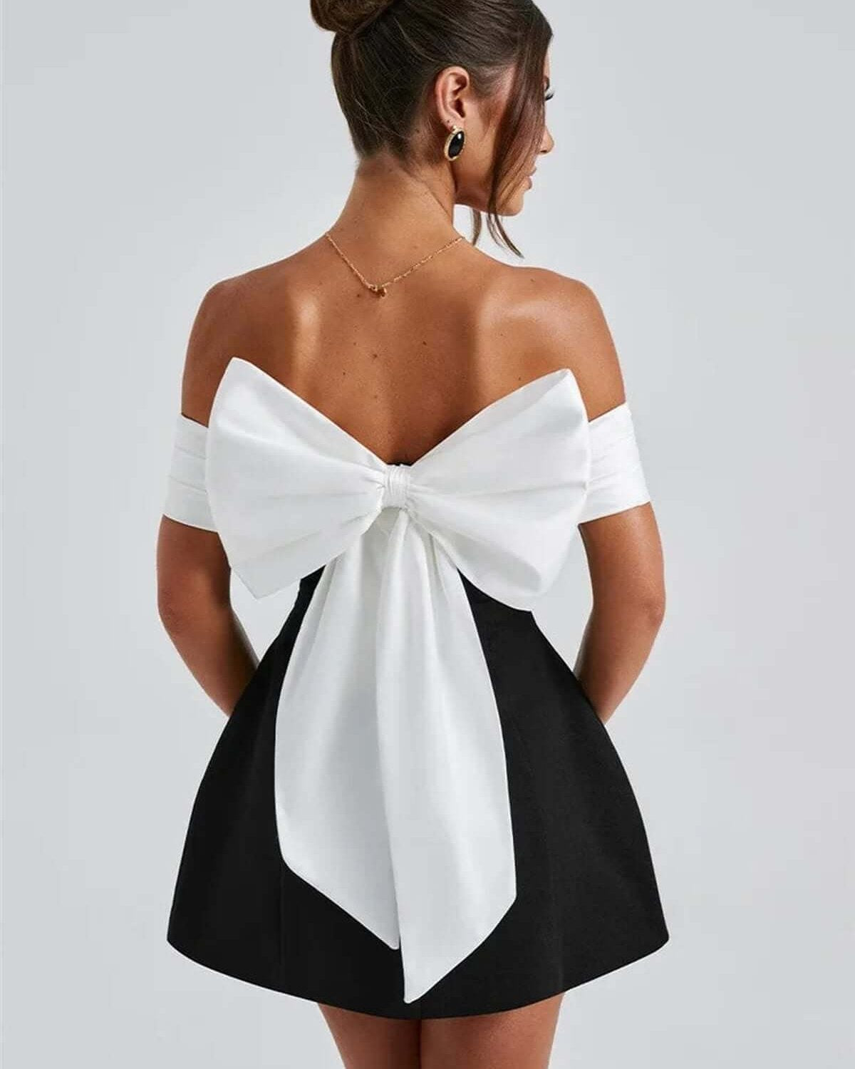 Elegantly designed Alba Mini Dress featuring an oversized white bow and off-shoulder satin neckline, perfect for special occasions.