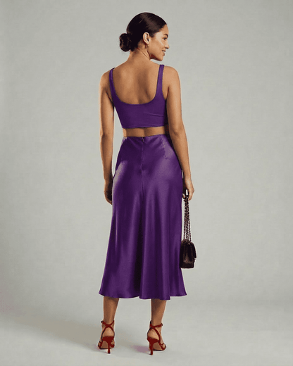 Back view of a model wearing the Slimona Amethyst Midi Skirt paired with a crop top.