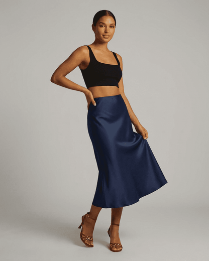 Astra Midi Skirt by Slimona, elegant satin mermaid midi skirt in deep navy blue, showcasing a sleek silhouette.
