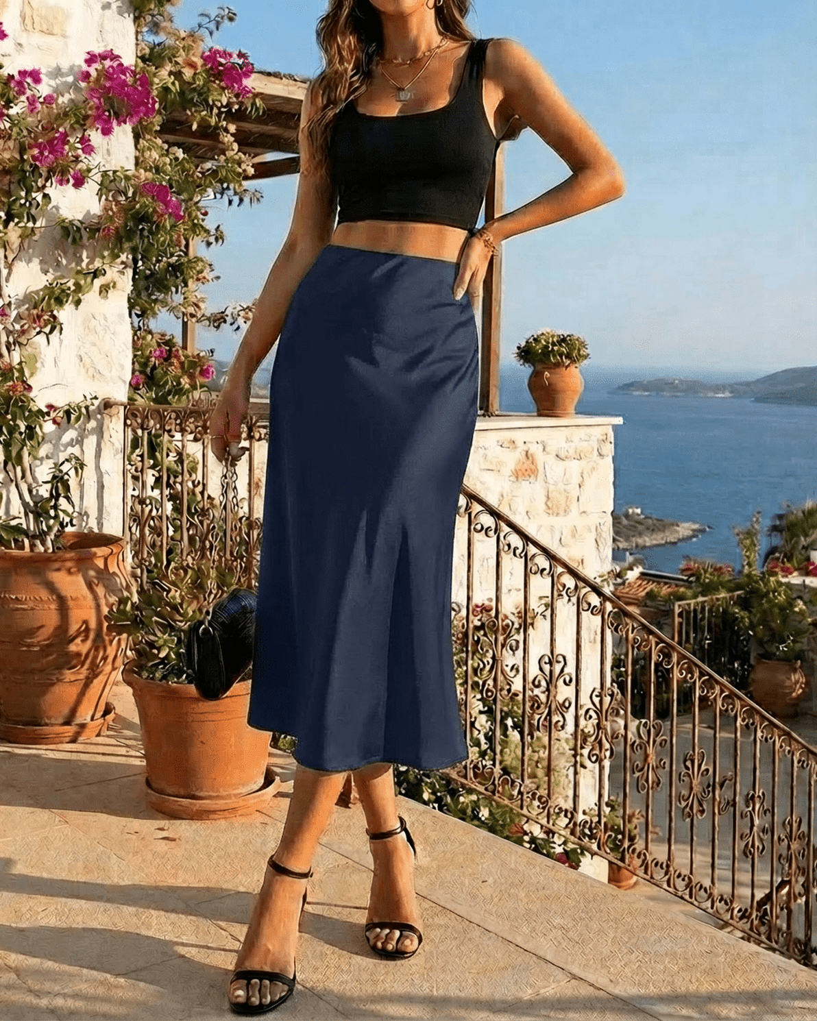 Astra Midi Skirt by Slimona, a satin mermaid midi skirt in deep navy, showcasing elegance by the seaside.