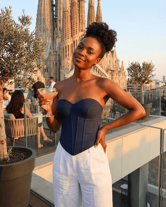 Model showcasing the Atlas Corset Top by Slimona, a faux denim bustier, against a stylish backdrop.