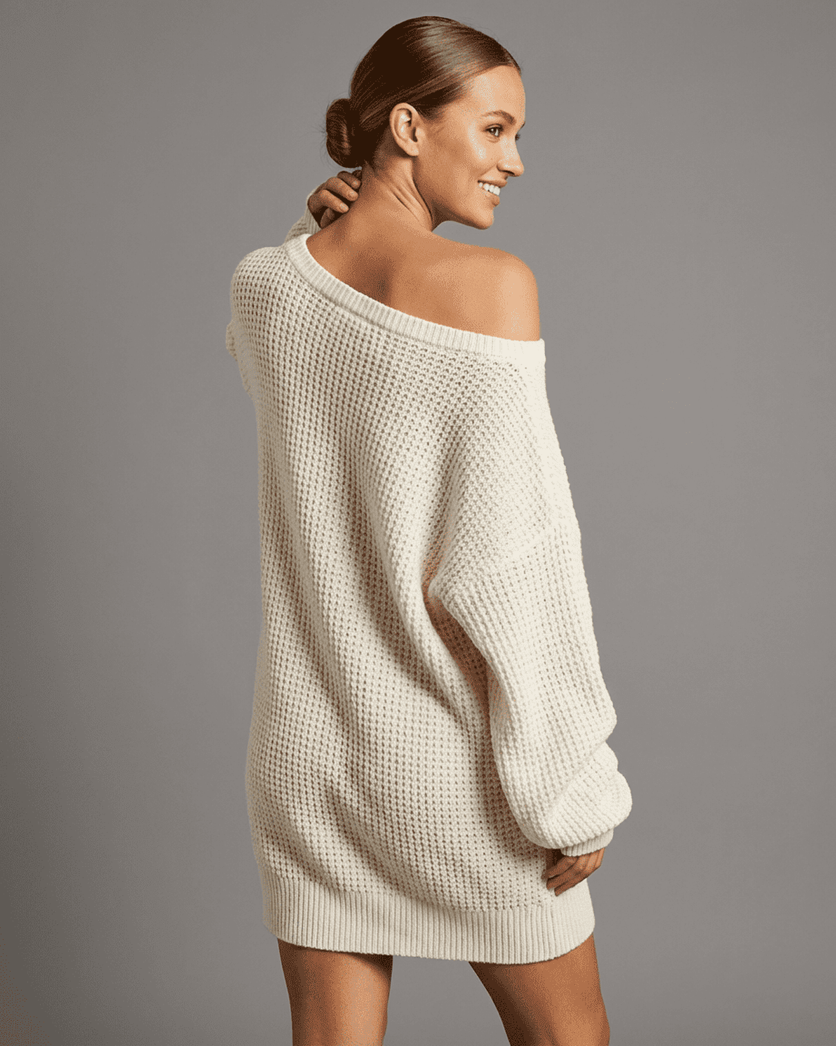 Model wearing the Aurora Mini Dress by Slimona, showcasing the off-the-shoulder design and cozy knit fabric.