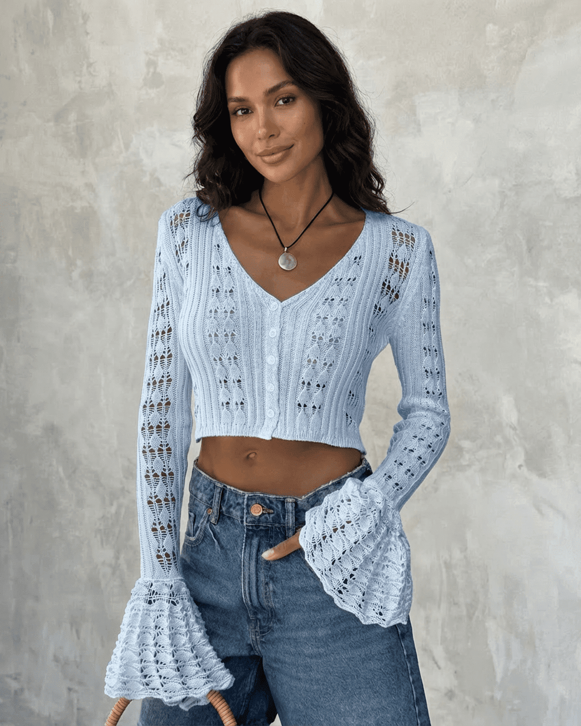 Azure Cardigan by Slimona, cropped cotton knit with flare sleeves, showcasing a soft blue color and unique hollow-out detailing.